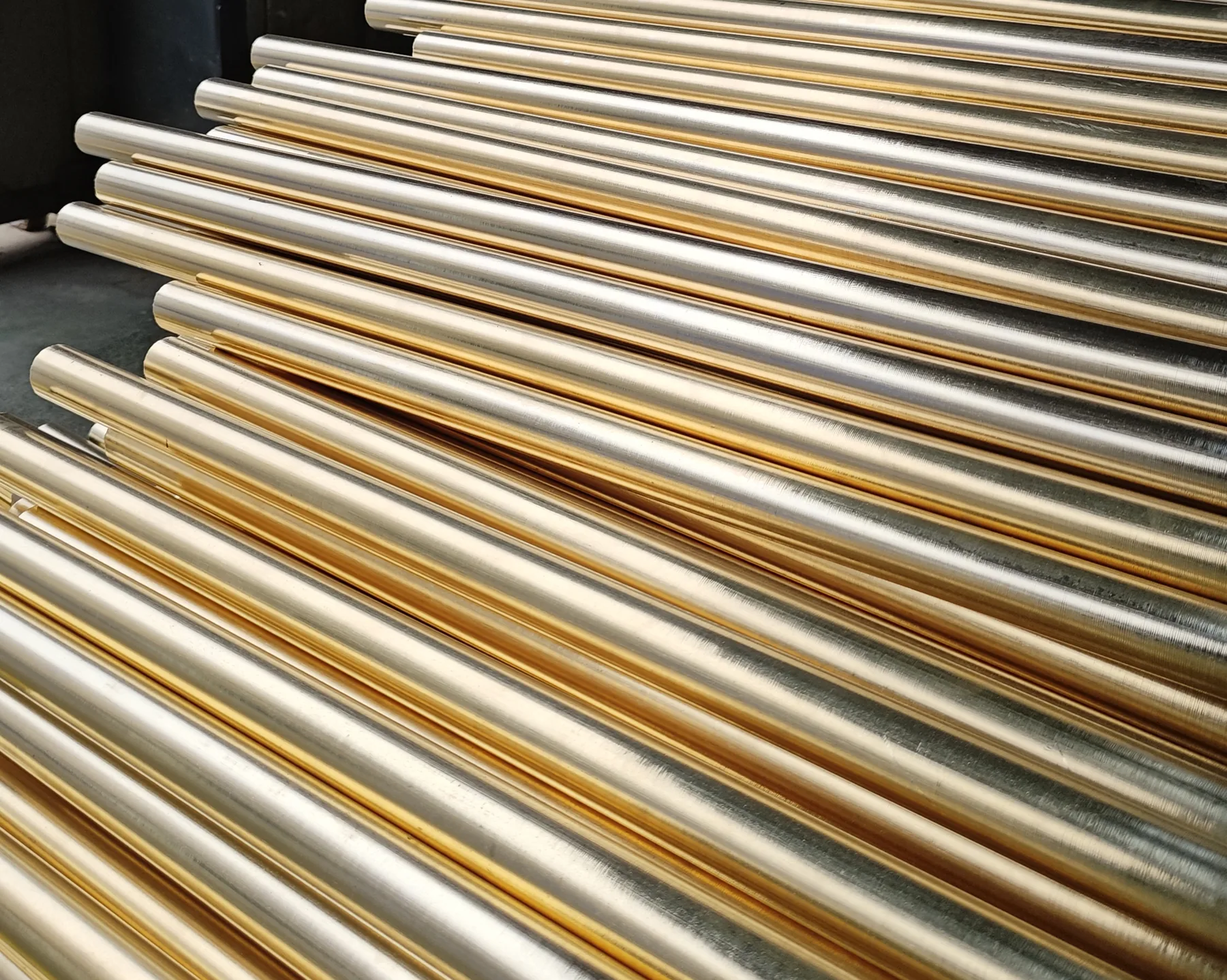 Brass bar stock staged for machining into plumbing fittings, where alloy grade decides dezincification resistance