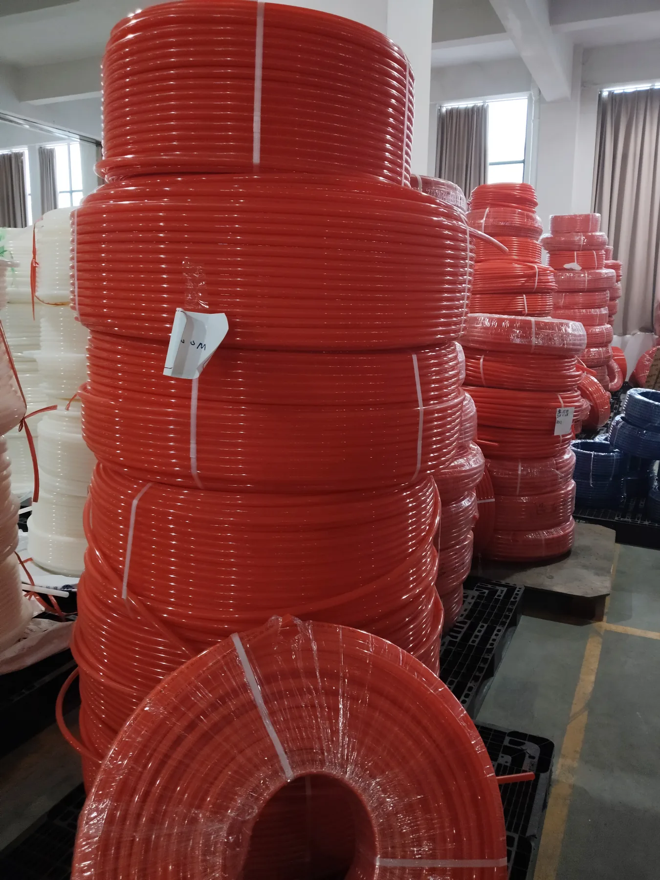 Stacked coils of WARMHAUS PEX pipe planned for container loads