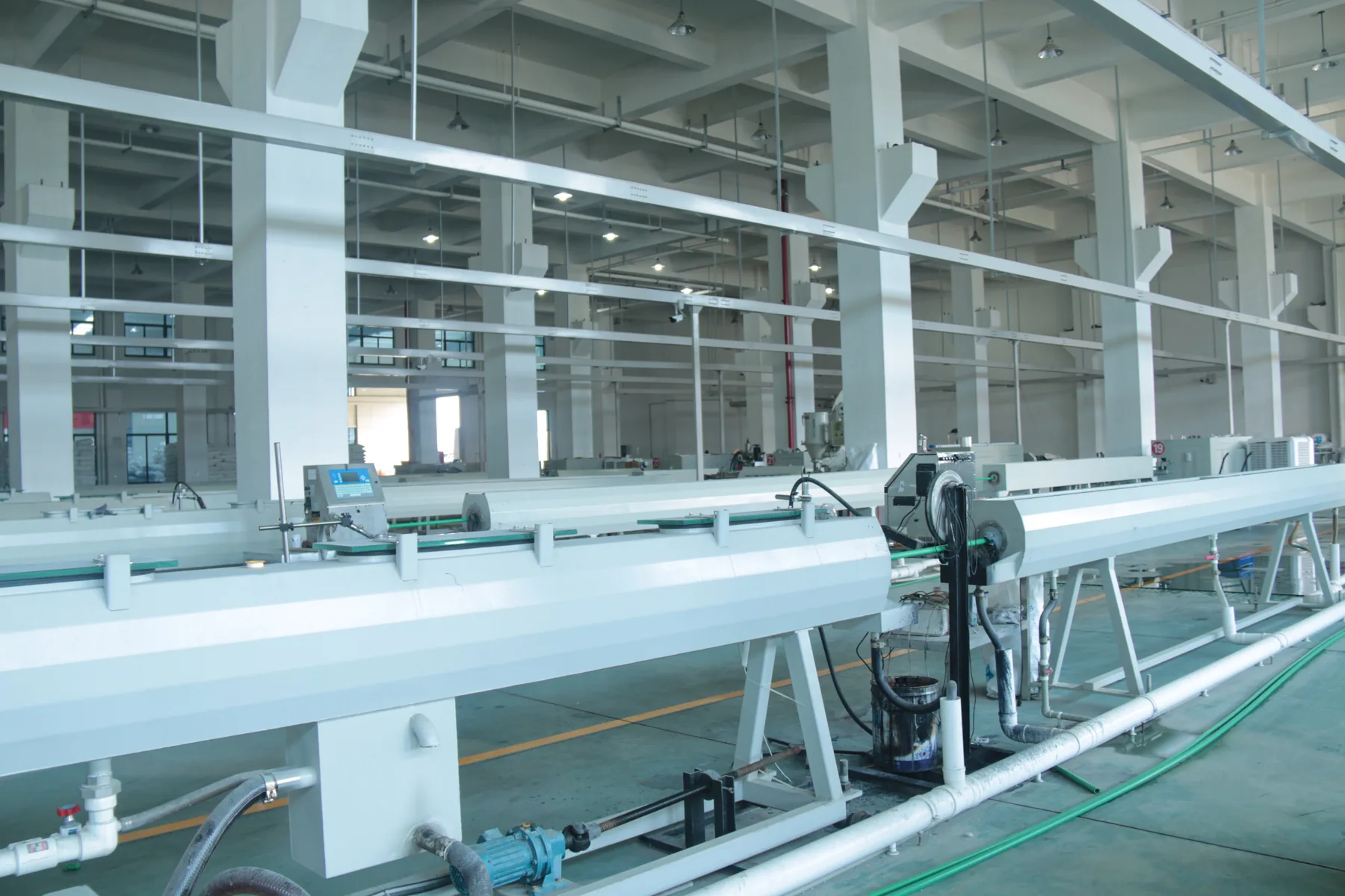 Finished PPR pipe bundles racked under cover in a production warehouse for protected storage