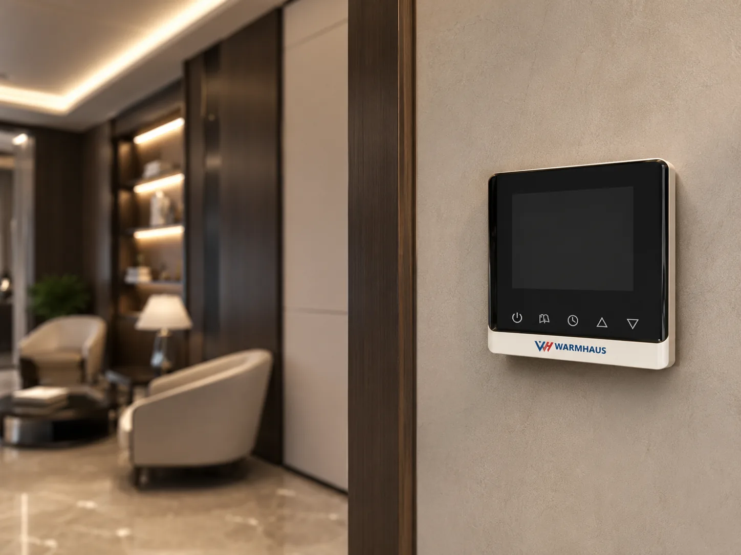 Underfloor heating thermostat mounted flush on a wall next to standard switch plates